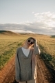 portrait of beautiful woman walking on field at sunset - PhotoDune Item for Sale