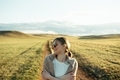 portrait of beautiful woman walking on field at sunset  - PhotoDune Item for Sale