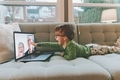 A little boy video chatting with his grandparents at home.  - PhotoDune Item for Sale