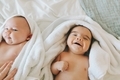 Two happy babies, wrapped in towels after a bath.  - PhotoDune Item for Sale