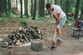 A man chopping wood at a campsite.  - PhotoDune Item for Sale