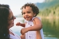 A mixed race little girl being picked up by her mother at the lake.  - PhotoDune Item for Sale