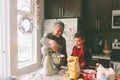 A grandmother and little boy baking in the kitchen with a standup mixer.  - PhotoDune Item for Sale