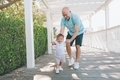 A father helping his son take his first steps. - PhotoDune Item for Sale