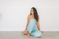 A happy indian woman sitting on the floor at home.  - PhotoDune Item for Sale