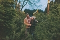 A happy couple together at a Christmas tree farm. - PhotoDune Item for Sale