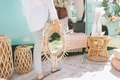 A woman holding a mirror, surrounded by beautiful home decor items staged in front of a camper van.  - PhotoDune Item for Sale