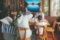 A family sitting together around a dining table in a cabin having a meal. - PhotoDune Item for Sale