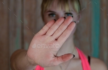 the girl shows a hand sign-negation,