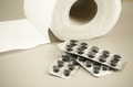 a roll of toilet paper and a sticker with charcoal tablets for diarrhea - PhotoDune Item for Sale