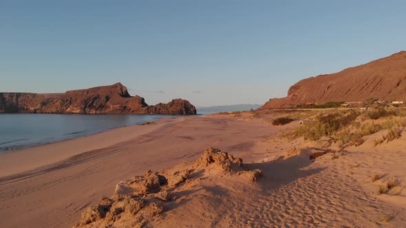 Low-level drone flight along Matadouro beach at sunrise. Portugal