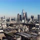 Reverse aerial view of London's Financial District skyscrapers on a sunny hazy day - VideoHive Item for Sale