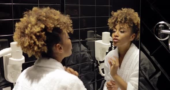 Confident Woman Grooming in Glass