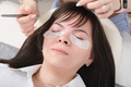 woman client lying in beauty salon redy to eyelash extension procedure.  - PhotoDune Item for Sale