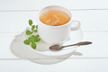 herbal tea with mint on a white wooden table. alternative medicine for gastrointestinal system  - PhotoDune Item for Sale