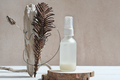 face care serum in white bottle on natural wooden podium next to modern still life set.  - PhotoDune Item for Sale