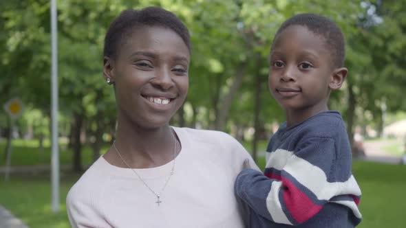 Portrait of Adorable African American Woman Holding Her Funny Son