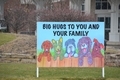 a sign in front of the hospital saying big hugs to you and your family - PhotoDune Item for Sale