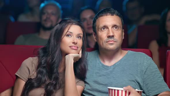 Closeup Pleasant Hispanic Couple Enjoy Romantic Film Hugging at Cinema Sitting Audience Row