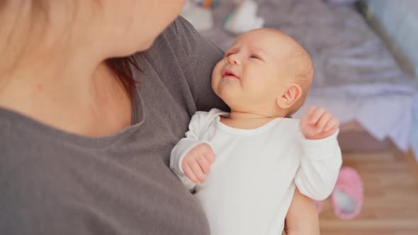 the Baby Lies in His Mother's Arms and Cries