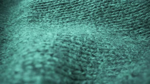 Extreme detail view of sheep wool cloth texture flowing in macro dolly shot.