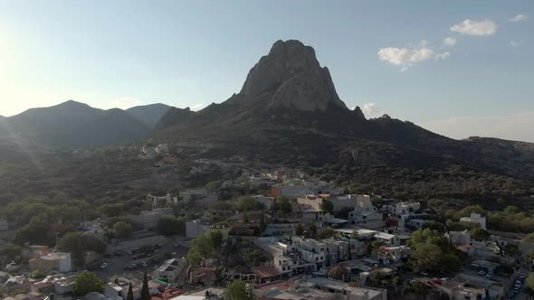 Aerial View Of The Pena de Bernal Monolith In Colonial Village Of Bernal, Queretaro, Mexico - drone