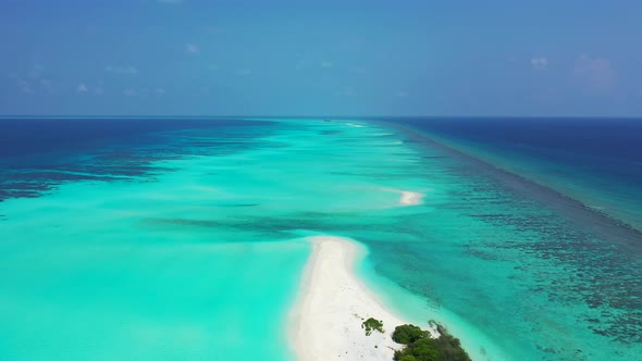 Wide angle above travel shot of a white sand paradise beach and blue sea background in high resoluti