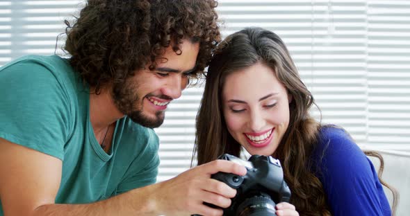 Photographer showing photos to fashion model