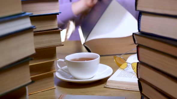 Female Hand Flipping Through the Pages of a Book Closeup