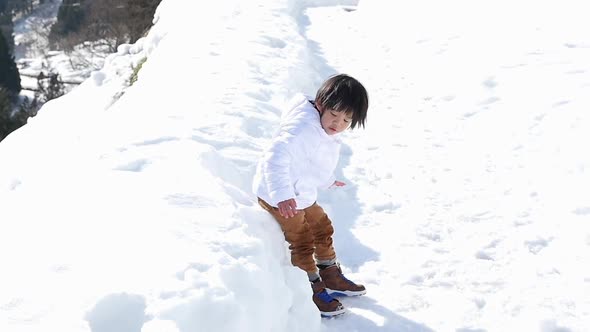 Cute Asian Child Playing Snow Outdoors