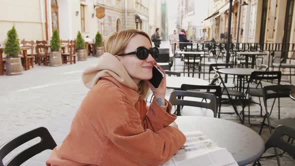 Girls Gathering in Coffee Shop and Talking Phone