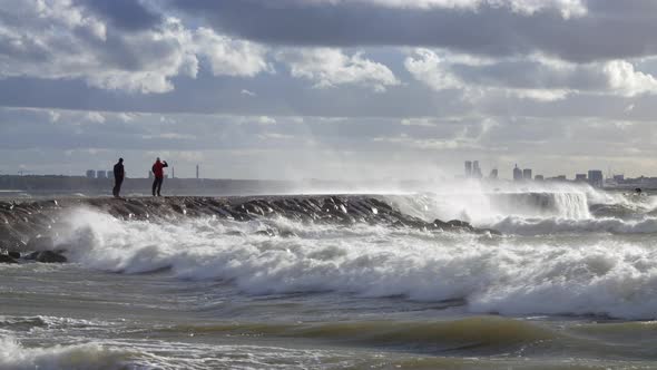 Man on the Pier Photographing Storm Waves