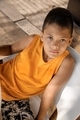 Summer portrait of young boy in orange tank top - PhotoDune Item for Sale