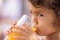 Little toddler girl drinking orange juice in the summer - PhotoDune Item for Sale