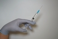 Hand holding a syringe - PhotoDune Item for Sale