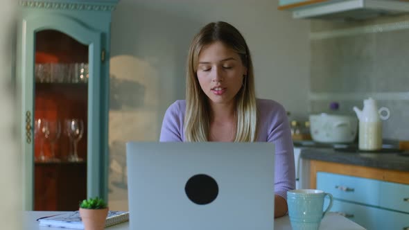 Young Woman Typing on Laptop Searching Information Getting Upset and Disappointed