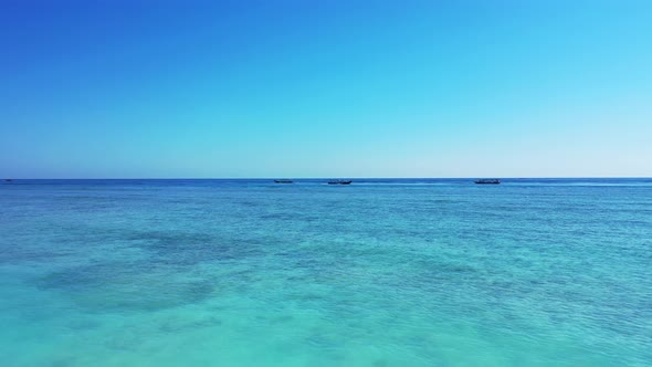 Luxury birds eye abstract shot of a white sandy paradise beach and aqua blue water background in vib