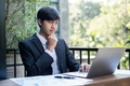 Young Asian businessman financial market analyst sits at their desks and calculate financial graphs  - PhotoDune Item for Sale