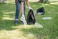 Man's hands pick up plastic bottles, put garbage in black garbage bags to clean up at parks, avoid - PhotoDune Item for Sale