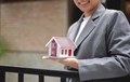 Home insurance concept and real estate. Businesswoman holding a house model working in investment - PhotoDune Item for Sale