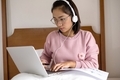 work from home, a young Asian woman who works in finance at home calculates financial graphs showing - PhotoDune Item for Sale