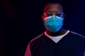 African-American man posing as doctor with safety glasses and blue mask again  a dark background - PhotoDune Item for Sale
