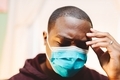 In pain or stressed, African American or black man in face mask looking upset - PhotoDune Item for Sale