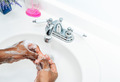 African American man at home washing hands in bathroom sink with soap and water  - PhotoDune Item for Sale