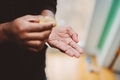 African-American men at home practicing good hygiene by using hand sanitizer - PhotoDune Item for Sale