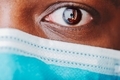 Close up of African American man’s brown eye wearing mask - PhotoDune Item for Sale
