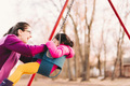 Mother and daughter at park playing on swing - PhotoDune Item for Sale