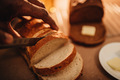 African American or black man cutting a slice of freshly baked artisan bread  - PhotoDune Item for Sale