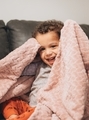 Diverse mixed race happy toddler boy at home on couch playing peek a boo with pink blanket laughing - PhotoDune Item for Sale
