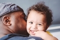 Black father with biracial son over shoulder bonding together  - PhotoDune Item for Sale